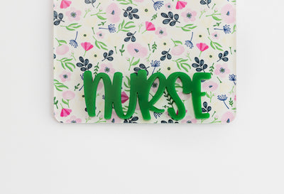 White Floral Badge Backer with Green Peachy Font