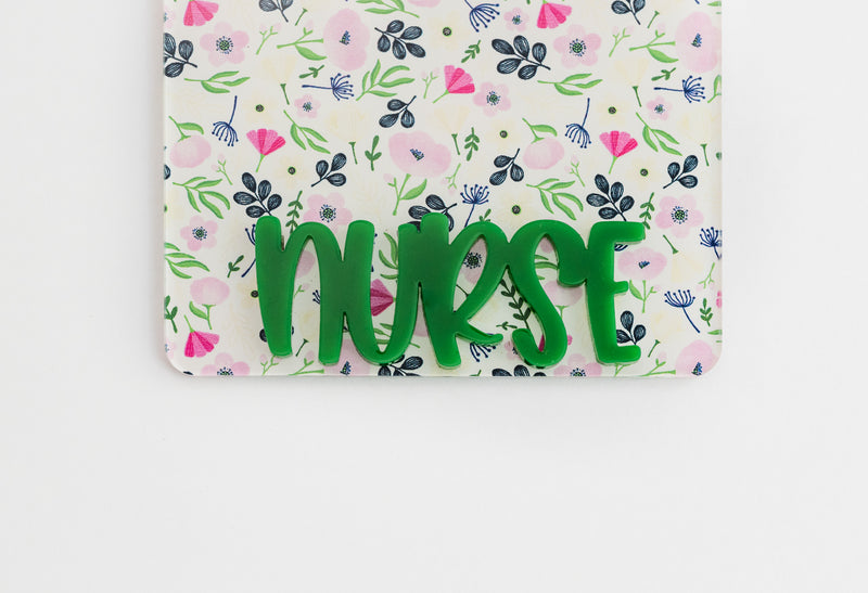 White Floral Badge Backer with Green Peachy Font