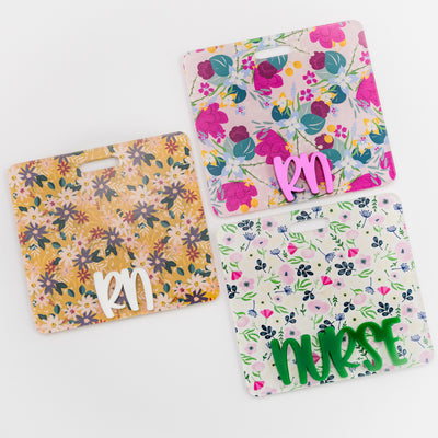 White Floral Badge Backer with Green Peachy Font